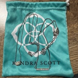 2 Kendra Scott silver necklaces.
